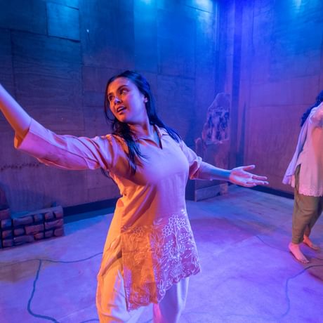 Two girls in ethnic clothing, enjoying dancing.