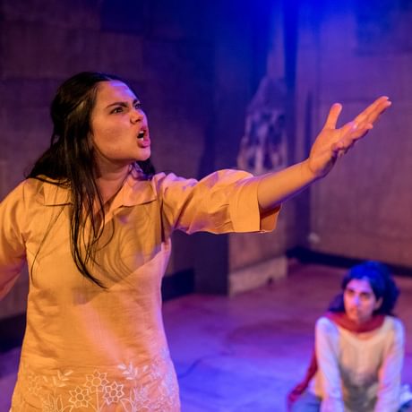 A girl delivering a speech with one arm up