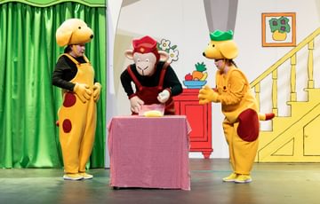 Spot the Dog with his friends looking at the cake on the table