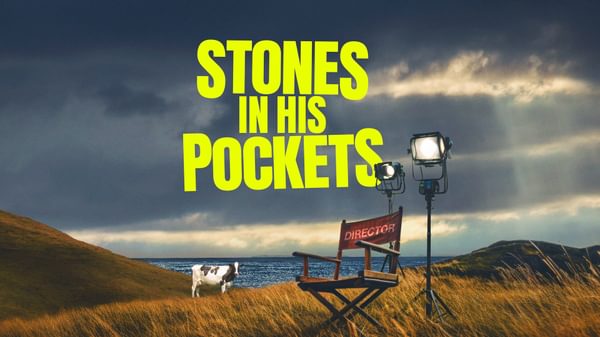 Stones in his pockets title with a director chair in a field and a cow in the background