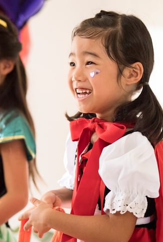 2 small children in costumes smiling