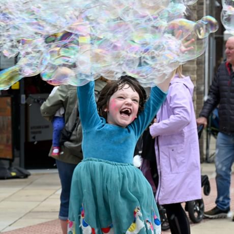 Child playing with bubbles