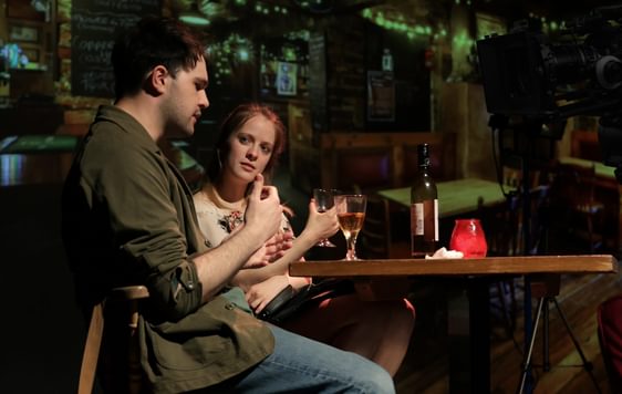 Image of a man and woman sat at a table on bar stools