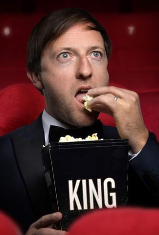 Image of Andrew Maxwell eating popcorn