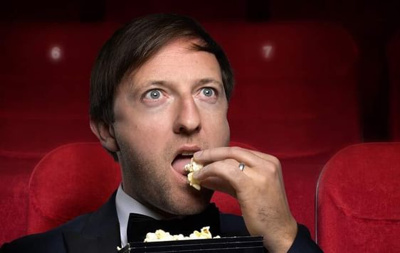 Image of Andrew Maxwell eating popcorn
